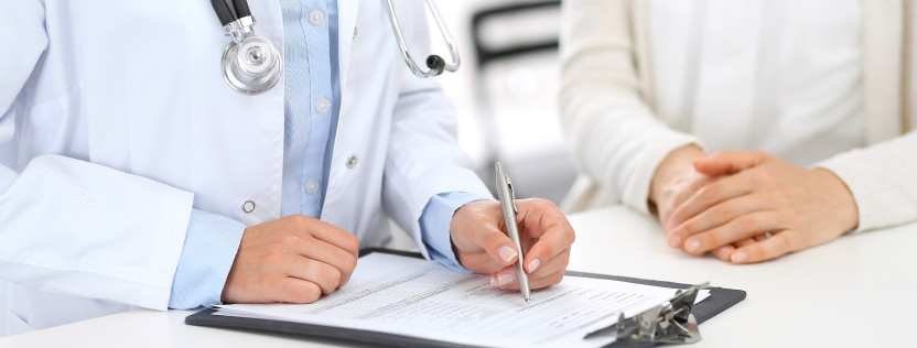 doctor writing on clipboard