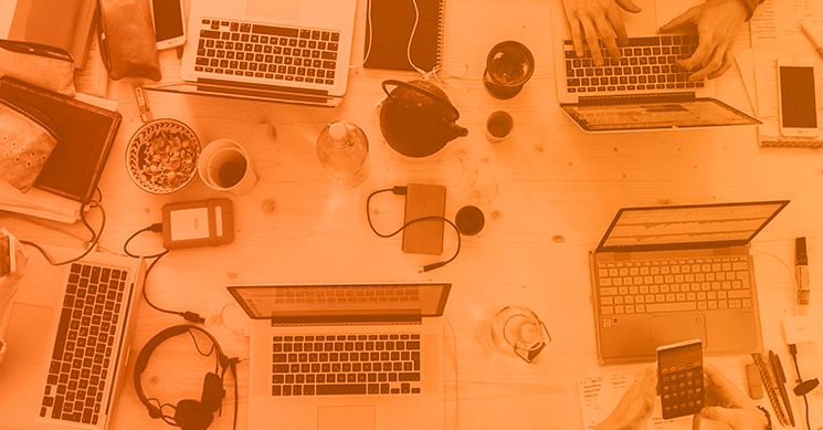 group of people hunkered down working on computers together