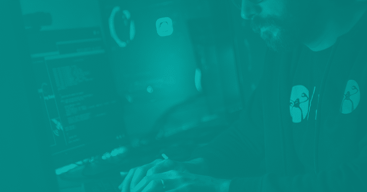 man at the computer working on code and hacking