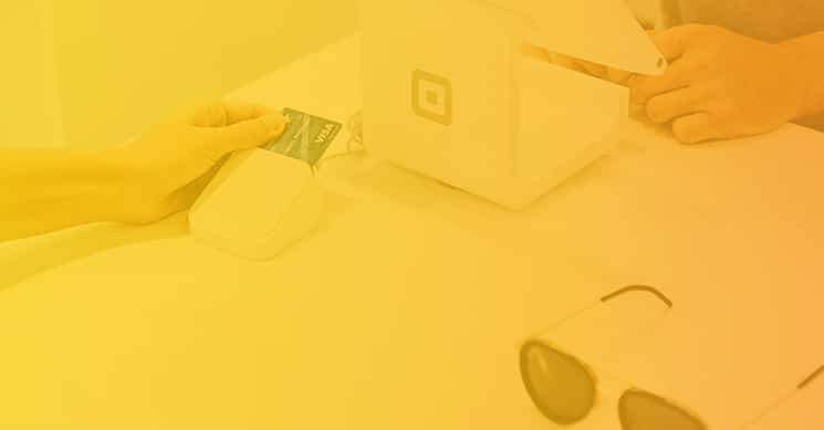 person paying for sunglasses with square reader credit card security
