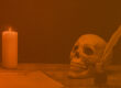 skull, quill pen, paper, and candle in an orange tint for incident response horror stories